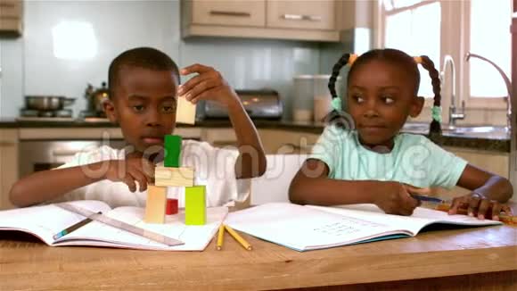 可爱的黑人兄弟姐妹在厨房玩视频的预览图