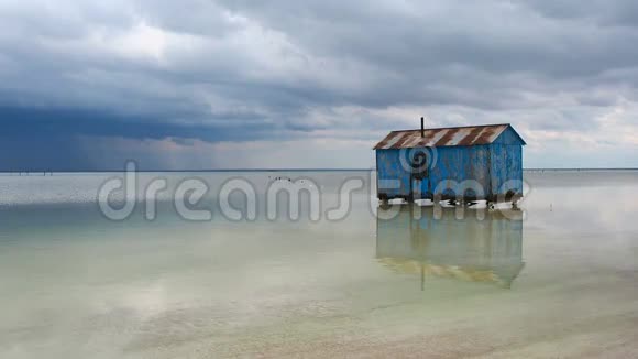 在一场即将来临的暴风雨中旧的蓝色房子被遗弃在盐湖中央SalaBaskunchak视频的预览图