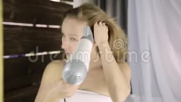 年轻女子在镜子前用毛巾擦干头发护肤和家庭水疗视频的预览图