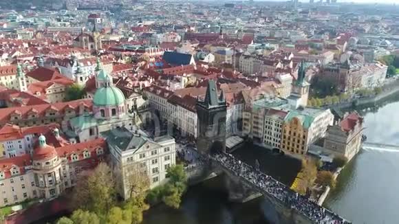 游客漫步在布拉格的查尔斯桥上从上面俯瞰全景伏尔塔瓦河飞过查尔斯河视频的预览图