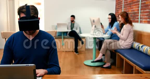 男性高管戴着虚拟现实耳机使用数字平板电脑视频的预览图