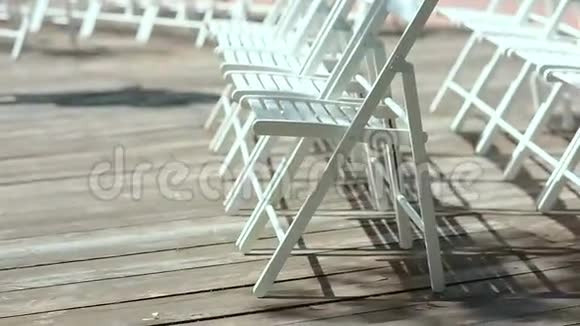 露天木制平台上的白色椅子视频的预览图