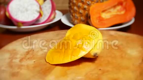 餐桌上的异国水果4k芒果西番莲水果切成块在砧板上旋转视频的预览图