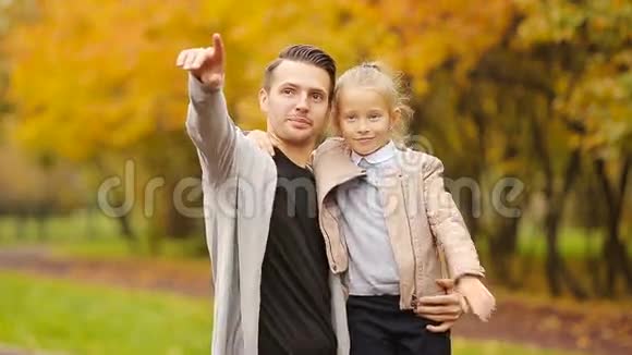 小女孩和快乐父亲的肖像喜欢秋天公园户外秋天的日子秋季家庭假期视频的预览图
