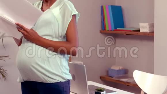 微笑着孕妇拿着文件夹视频的预览图