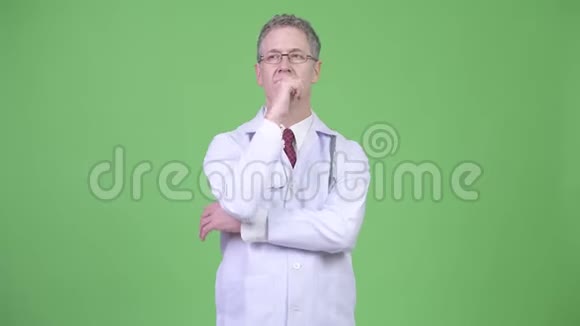 一幅成熟的男医生边看边思考的画像视频的预览图