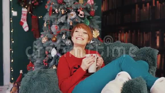 美丽的红发女人在扶手椅上视频的预览图