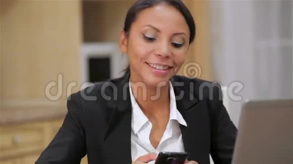 忙碌的女商人用手机发短信视频的预览图