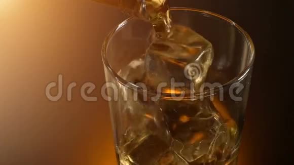 巴曼把威士忌倒在玻璃杯里倒着倒影温暖的夜晚气氛视频的预览图