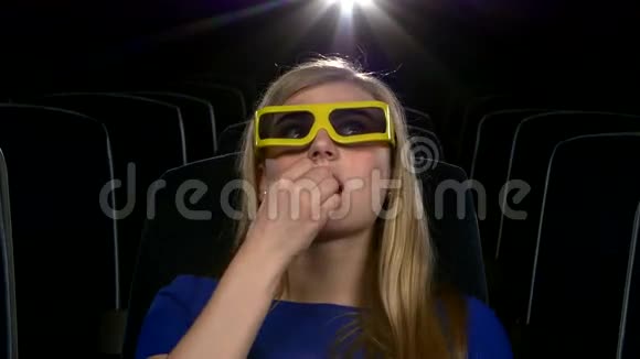 在电影院3D有魅力的年轻女孩吃东西视频的预览图
