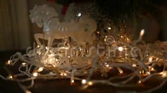 塑料玩具马在圣诞树上的花环上杉树枝上的花瓶视频的预览图