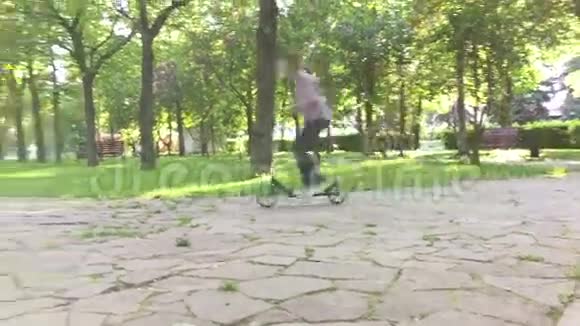 在公园玩滑板车的男孩视频的预览图