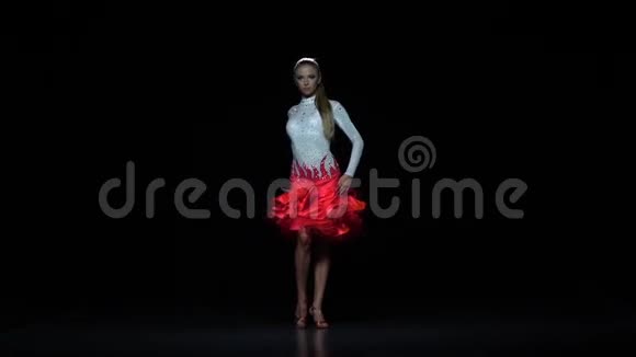 迷人的女孩舞蹈元素萨尔萨黑暗的背景慢动作视频的预览图