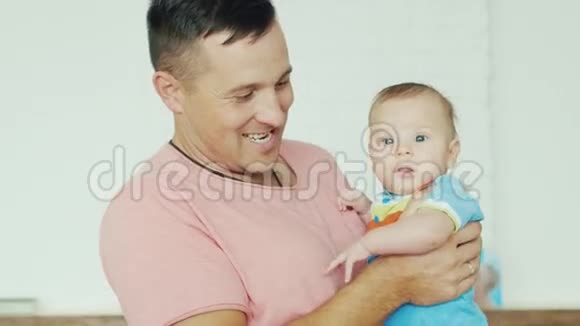 年轻快乐的父亲抱着儿子视频的预览图