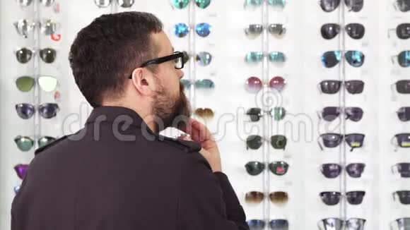 成熟男性顾客在眼镜店选择眼镜视频的预览图