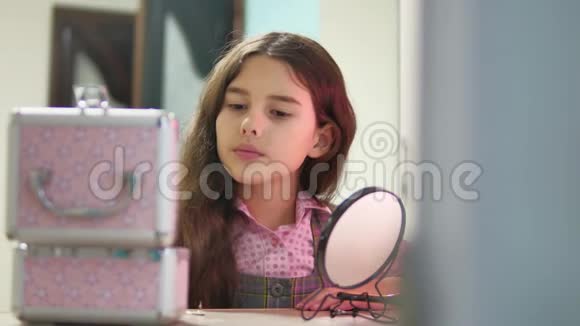 小女孩梳头做发型少女梳头室内镜子视频的预览图