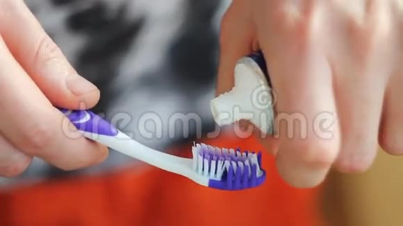 男人在刷子上挤牙膏视频的预览图