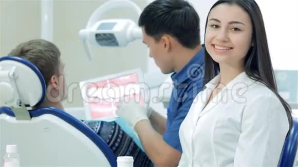 牙科医生用白色药片显示病人视频的预览图