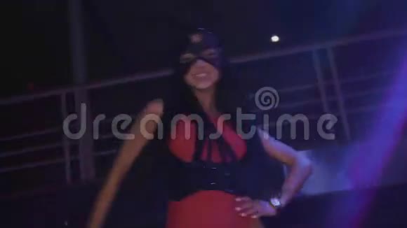 MC女孩戴着兔子面具红色紧身衣在夜总会舞台上表演聚光灯视频的预览图