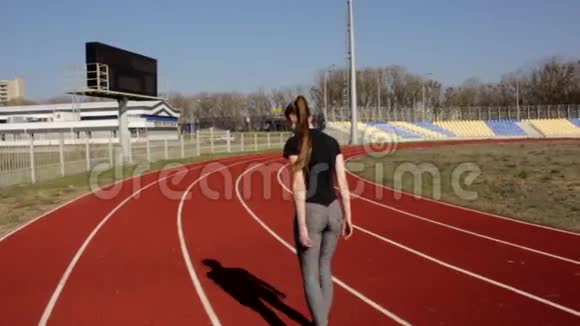 适合运动的年轻有魅力的女子在阳光明媚的春天进行马拉松慢跑户外体育场锻炼视频的预览图