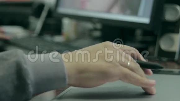 摄影师在笔记本电脑上绘制和润色图像使用数字平板电脑和手写笔特写男人的手视频的预览图