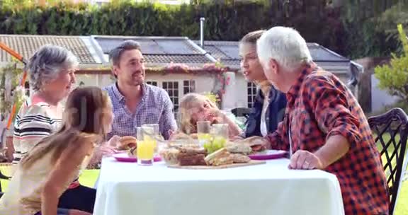 多代家庭在花园里吃饭视频的预览图