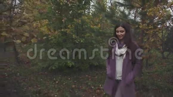 在秋天的森林里散步的年轻美女视频的预览图
