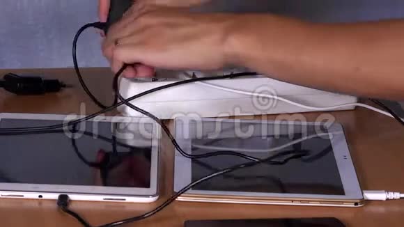 女性手插装置充电器桌子上的延长插座视频的预览图