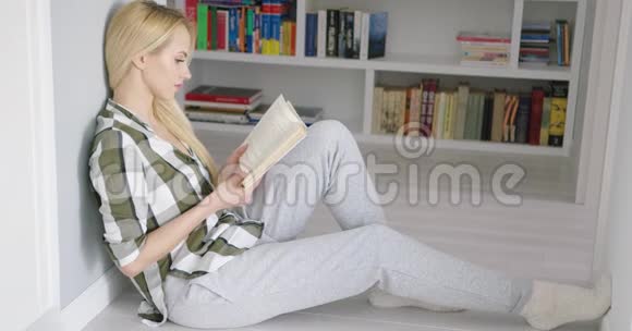 坐在地上拿着书的女人视频的预览图