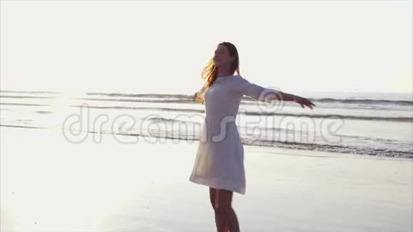 快乐的女人在海滩上旋转视频的预览图