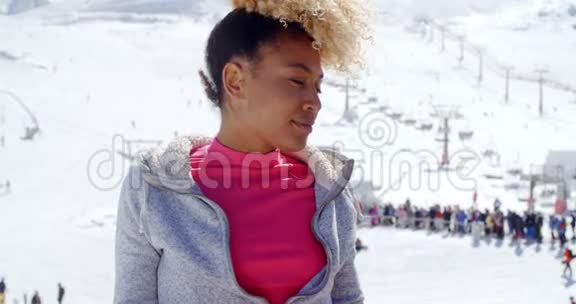 一位在高山滑雪场的时髦年轻女子视频的预览图