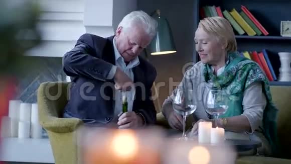 老人和妻子坐在一起打开酒瓶视频的预览图