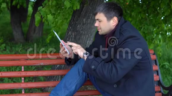 那个人在公园里用平板电脑视频的预览图