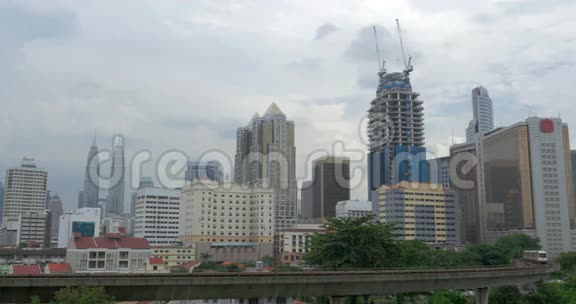 火车的前景和现代建筑的背景摩天大楼马来西亚吉隆坡视频的预览图
