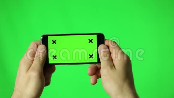 绿色屏幕智能手机男手细节在景观中玩游戏视频的预览图