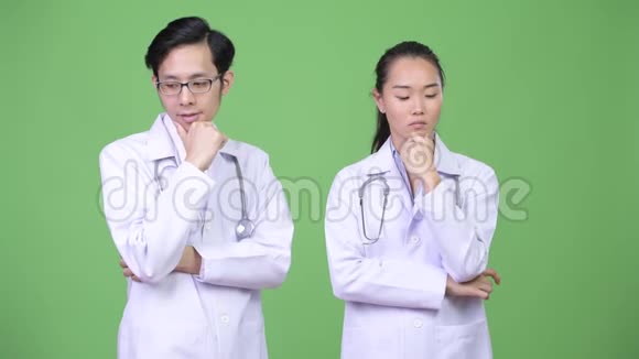 年轻的亚洲夫妇医生在一起思考视频的预览图