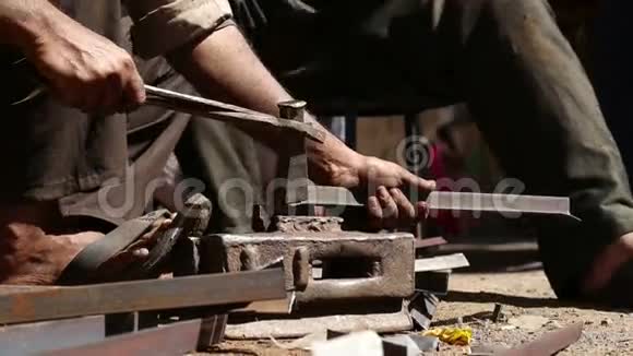 两个人用木槌形成金属棒视频的预览图