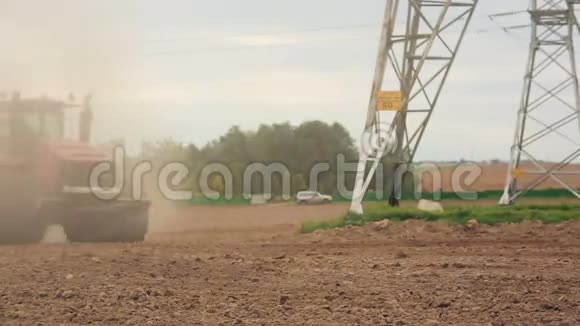 农业拖拉机在播种前耕田山和森林的背景全世界的土壤尘埃视频的预览图