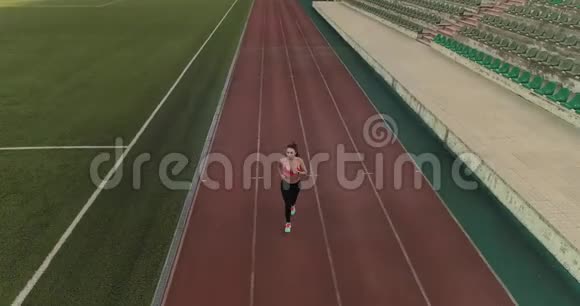 空中飞行体育女运动员在体育场慢跑体育运动中穿运动服的年轻女孩视频的预览图