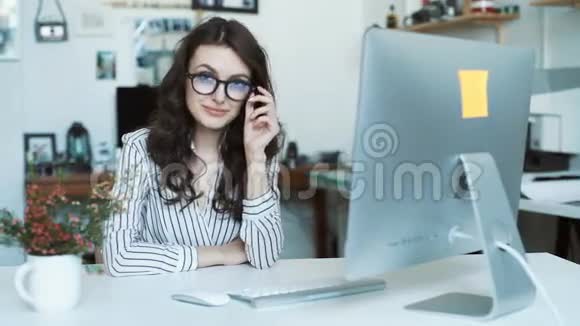 年轻女性在办公室或学校使用平板电脑看镜头视频的预览图