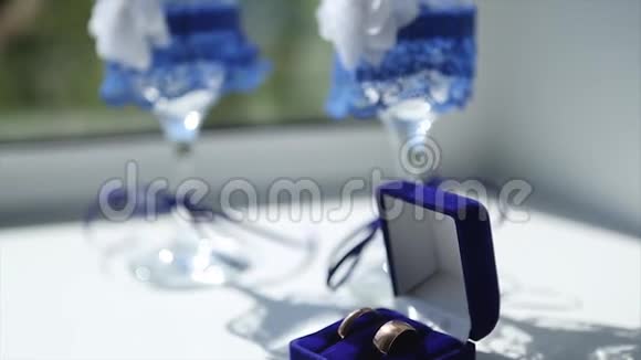 婚礼当天早上婚礼戒指和婚礼酒杯放在桌子上视频的预览图