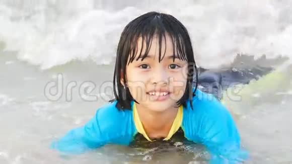 亚洲小孩在沙滩上冲浪视频的预览图