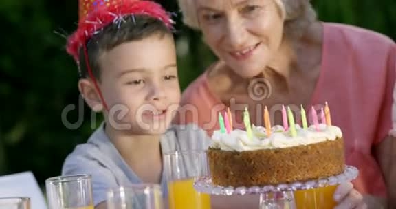 小男孩在看他的生日蛋糕视频的预览图