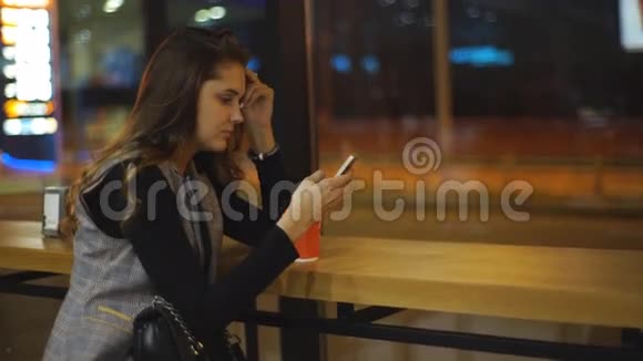 女孩在加油站喝咖啡用电话视频的预览图