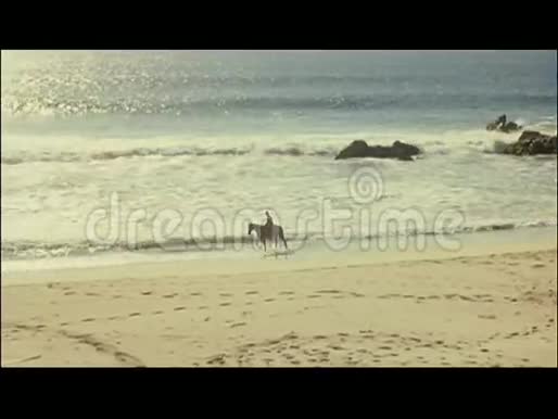宽镜头或人骑在沙滩上视频的预览图