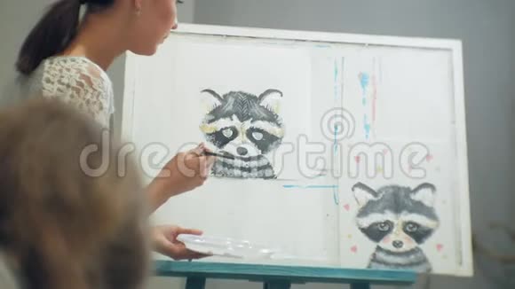 一位年轻英俊的老师在黑板上画画在美术课上教书视频的预览图