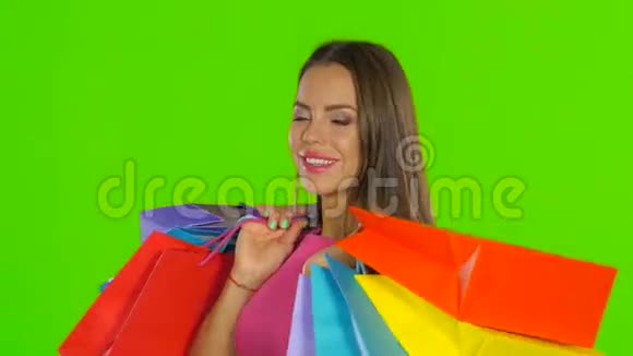 女人拿着购物袋微笑着绿色屏幕关门视频的预览图