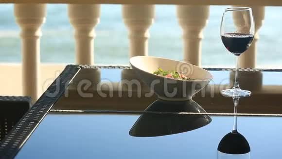 美食餐厅的一道菜特写镜头猪肉配蔬菜和一杯红酒海滨餐厅视频的预览图