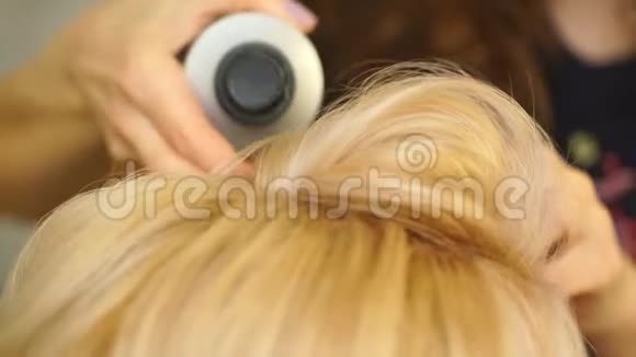 金发碧眼的金发女孩在美容院做理发师的卷卷视频的预览图