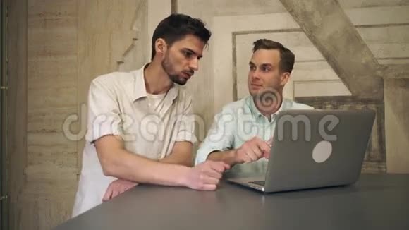 两个男人的朋友在电脑上看着笑视频的预览图
